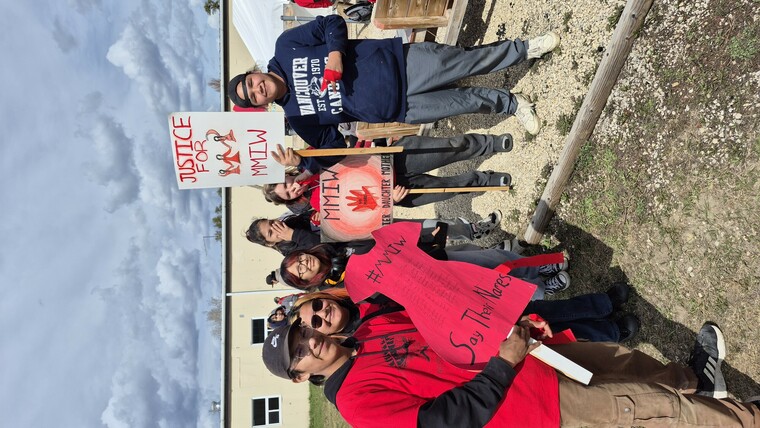 Students with signs and are ready for the walk.