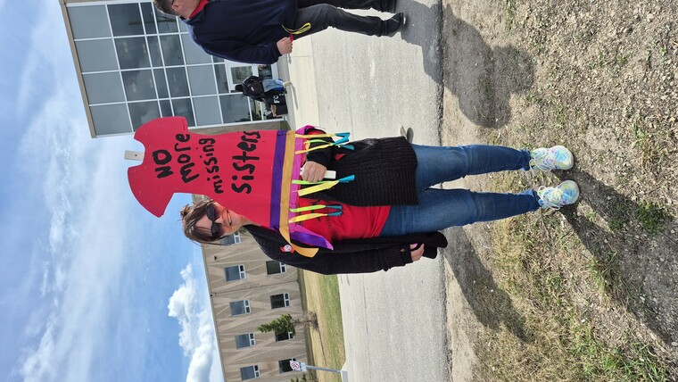 Shannon holding up a sign, reading "No more missing sisters"