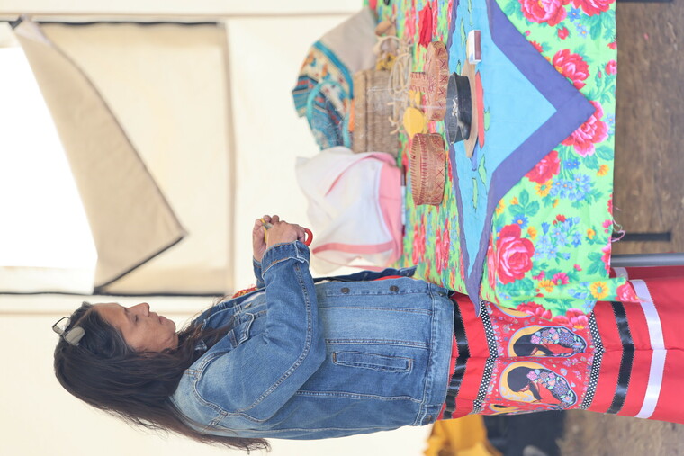 An Elder showing, making medicine pouches.