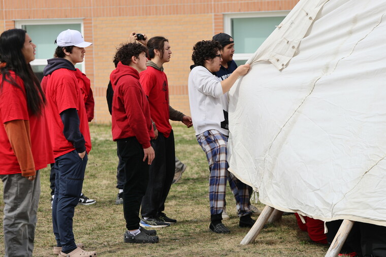 Students learning to put up the Tipi cover and the ceremony.